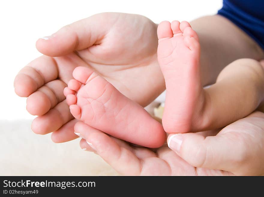 Heels of the baby in hands of mother. Heels of the baby in hands of mother