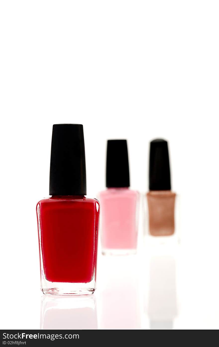 Shallow focus image of three nail polish containers