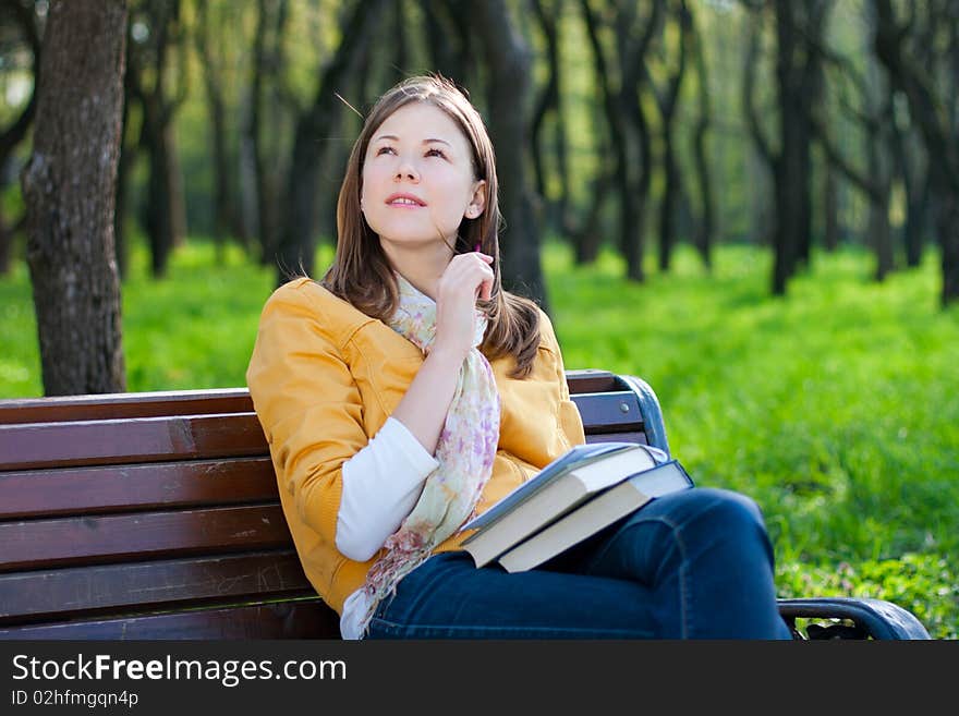 Woman With Book In Park