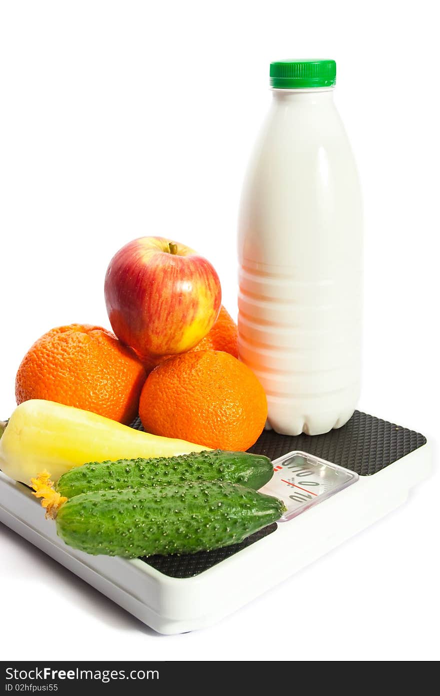 Vegetables on the scales, isolated on white. Vegetables on the scales, isolated on white