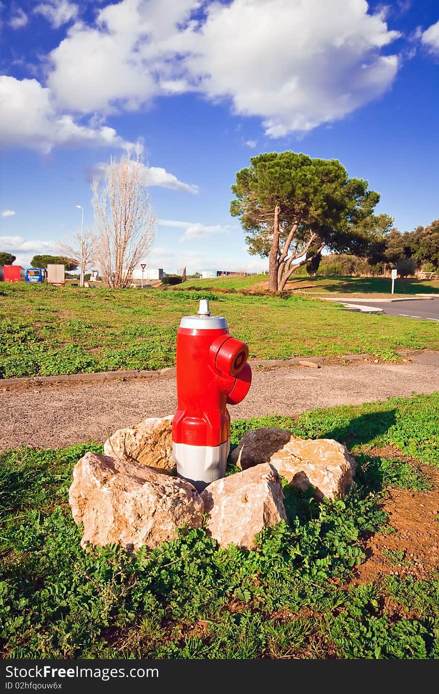 Red fire hydrant between the stones in the countryside