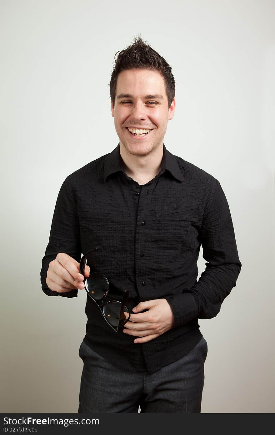 Young man standing and laughing. Young man standing and laughing