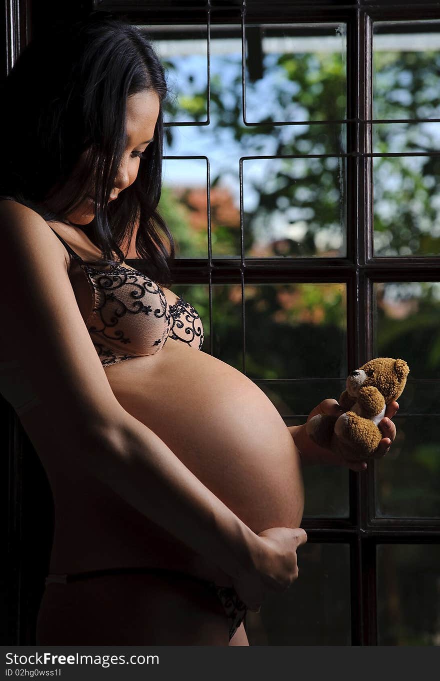 Cute teddy bear and unborn baby become friends. Cute teddy bear and unborn baby become friends