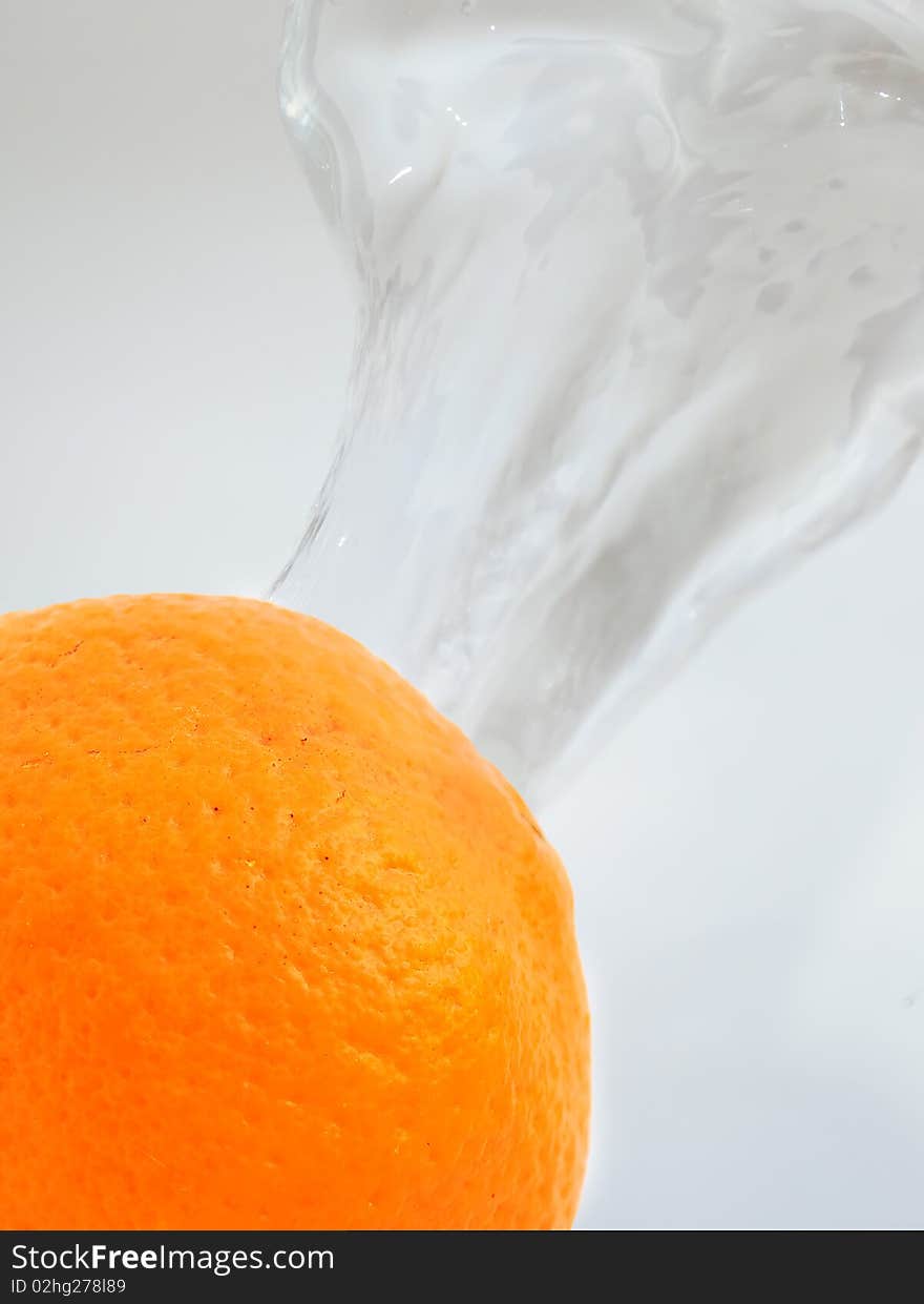 An orange on splashing water background. An orange on splashing water background