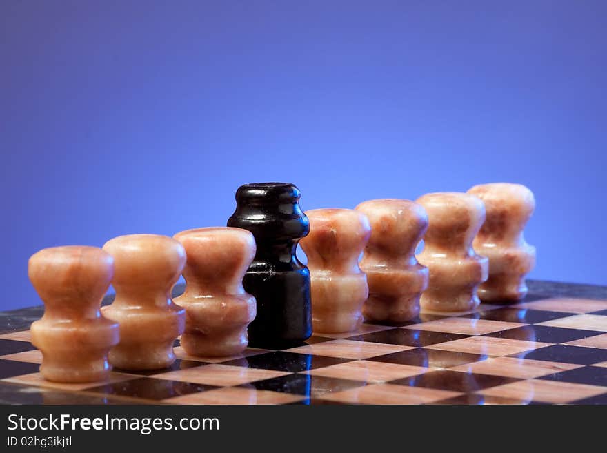 Marble chess on chessboard with blue background