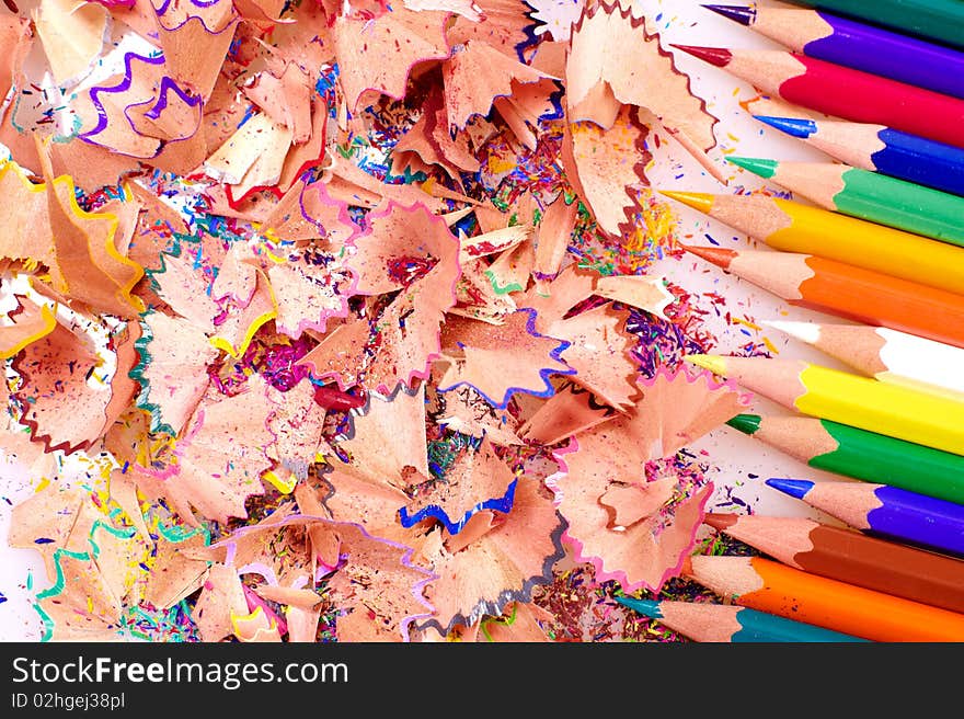 Multicolor pencils and wood shavings background