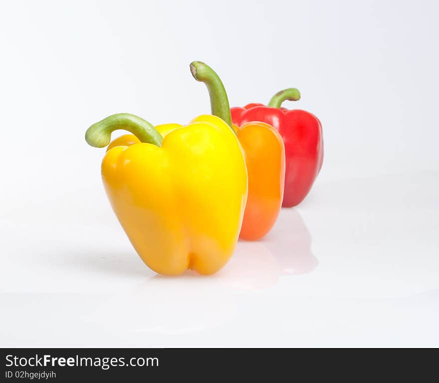 Three different color peppers on white background. Three different color peppers on white background