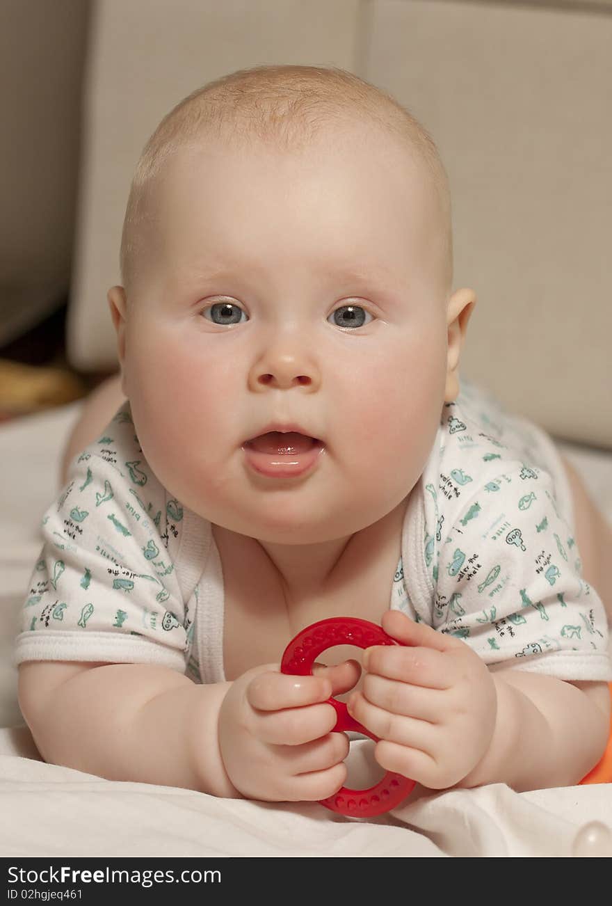 Portrait of a lying baby girl (9 months) at home