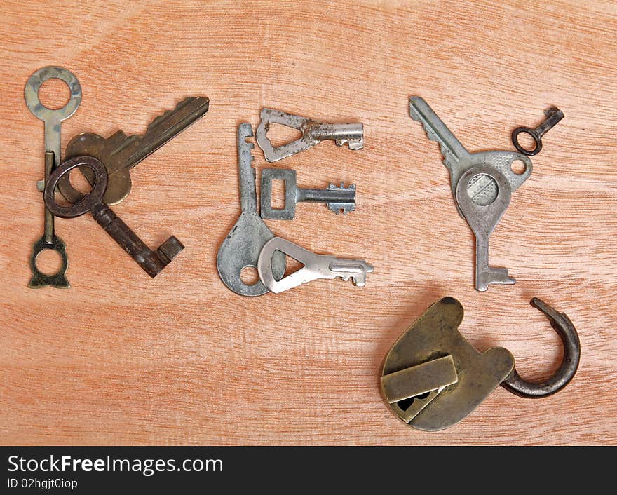 Old padlock and keys on wooden background. Old padlock and keys on wooden background