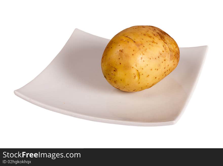 Potato on the plate isolated in white