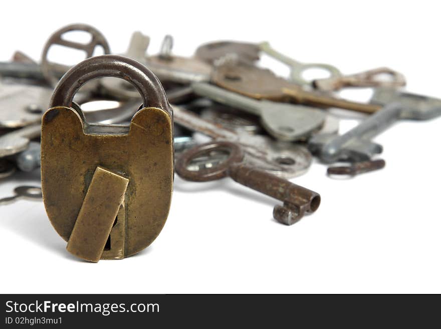 Old padlock and heap of keys isolated on white. Old padlock and heap of keys isolated on white