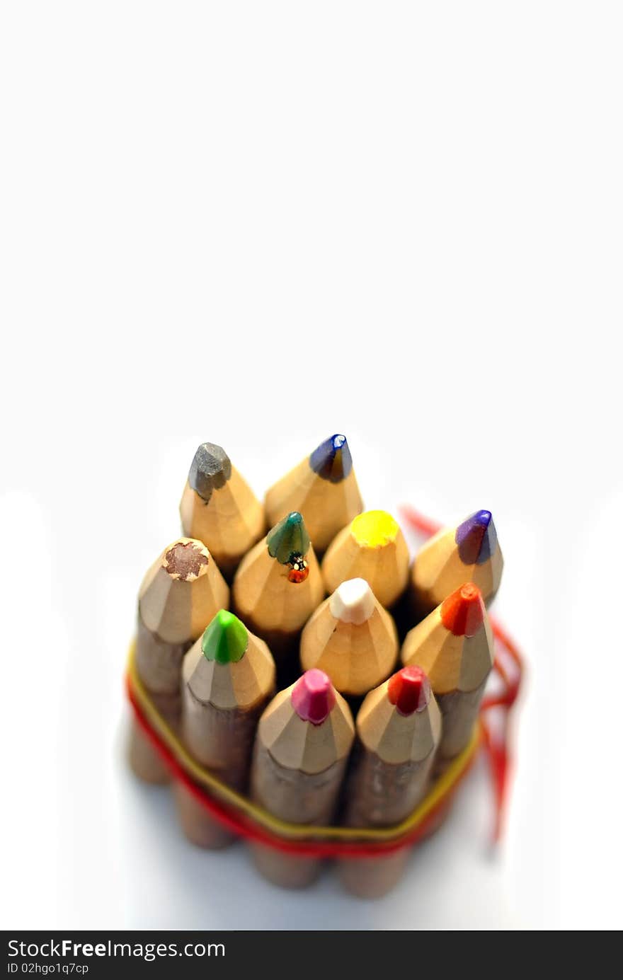 Ladybug on color pencils isolated on white