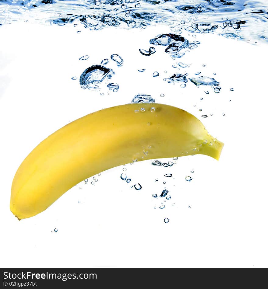 Banana dropped into water isolated on white