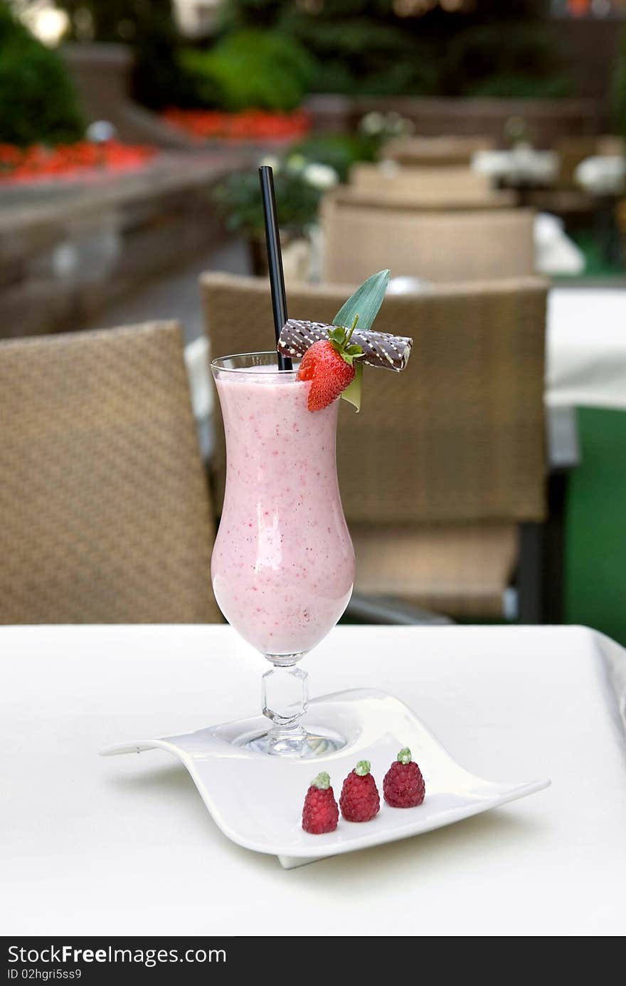 Strawberry milkshake in a glass on the table. Strawberry milkshake in a glass on the table