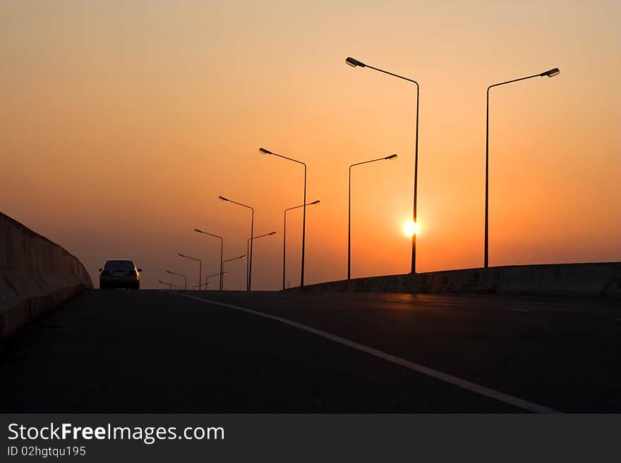 Car on the bridge at sunset. Car on the bridge at sunset