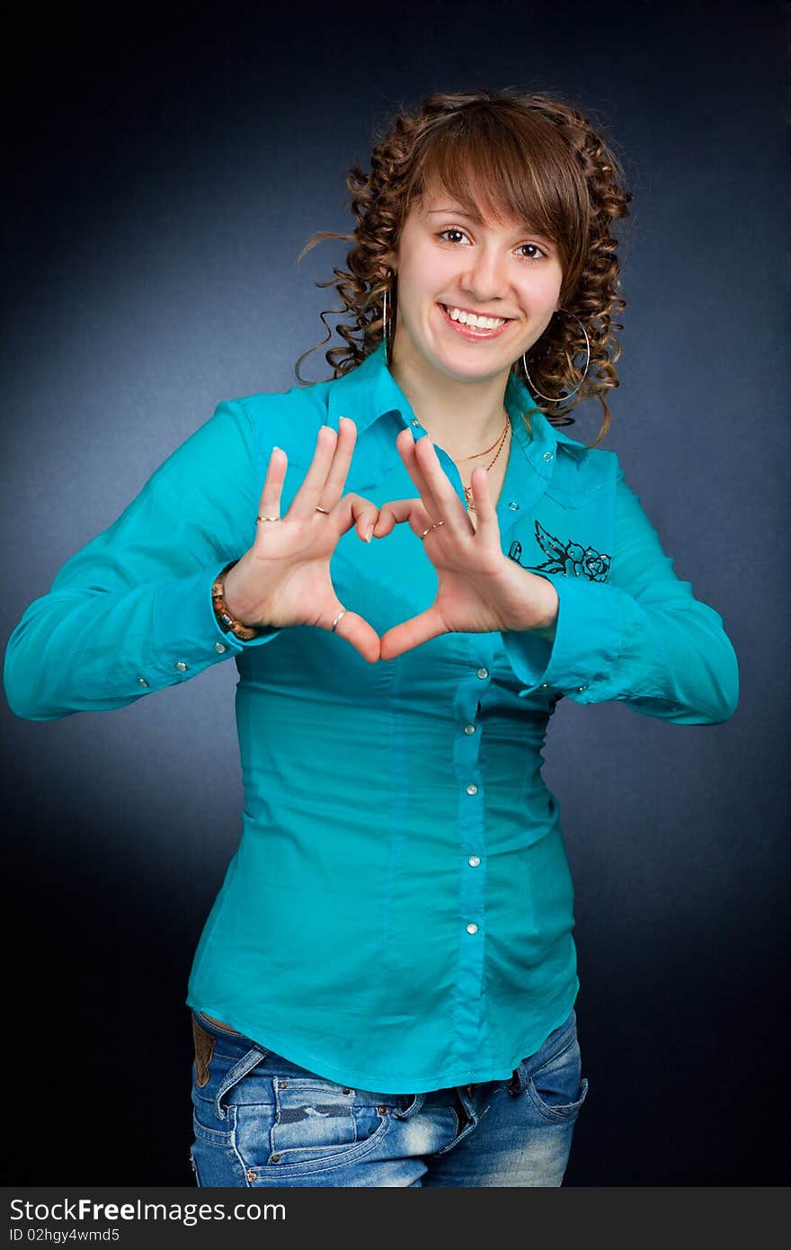 Form of heart shaped by the hands of a beautiful young women. Form of heart shaped by the hands of a beautiful young women