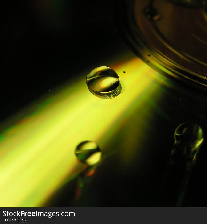 Water drops on yellow mirror surface