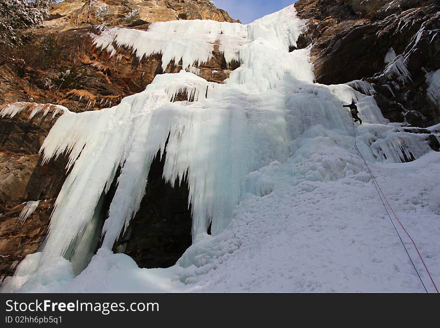 Huge icefall with small iceclimber