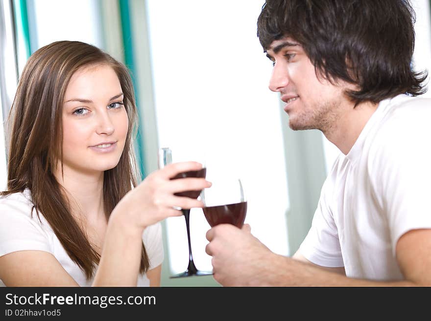 Long-haired girl with smile and boy with wineglasses. Long-haired girl with smile and boy with wineglasses