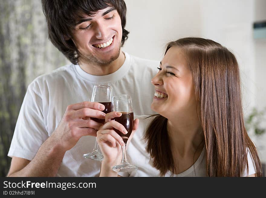 Nice girl with smile and boy with wineglasses. Nice girl with smile and boy with wineglasses