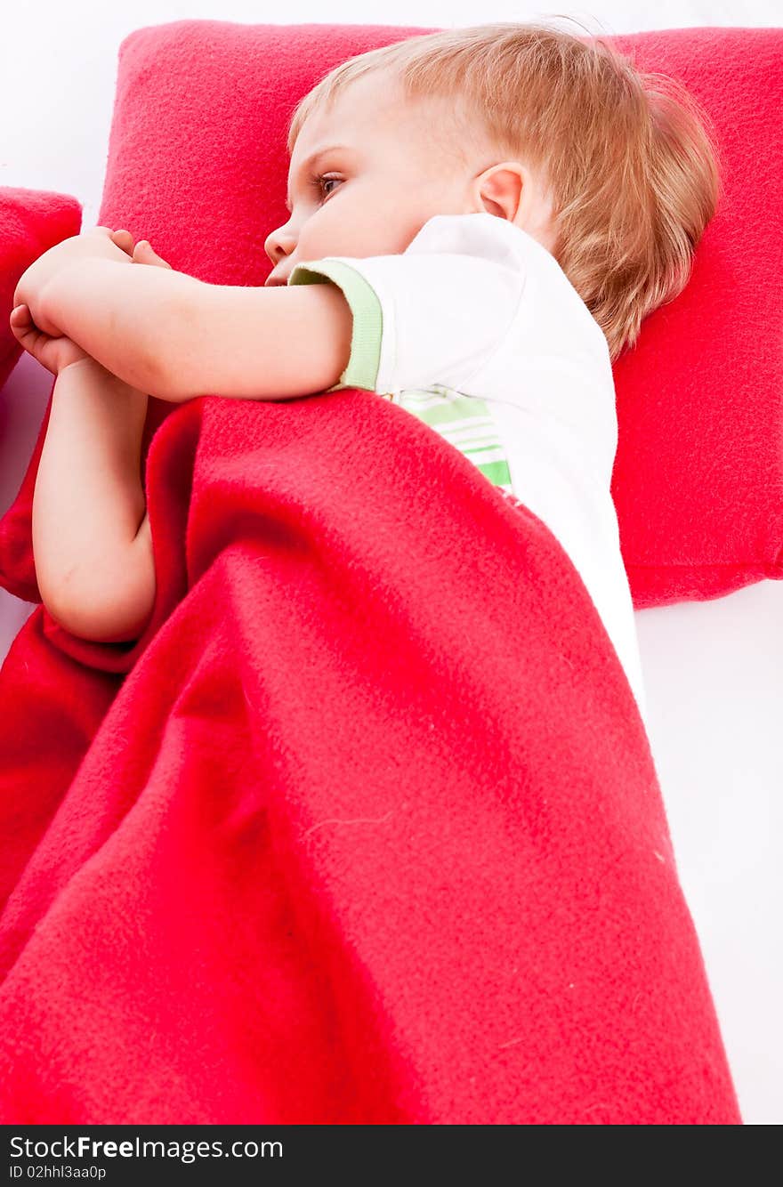 Little boy is sleeping on a red pillow. Little boy is sleeping on a red pillow