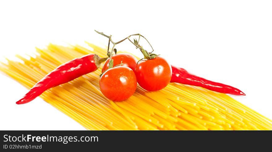 Red hot chilli peppers, tomatoes and pasta isolated on white