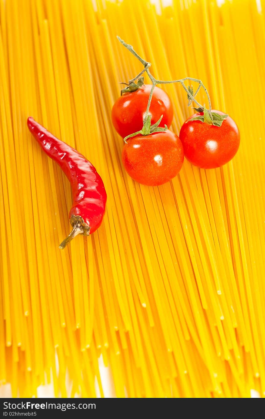 Red hot chilli peppers, tomatoes and pasta isolated on white