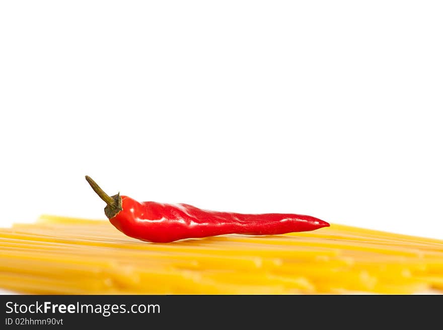 Red hot chilli peppers and pasta isolated on white