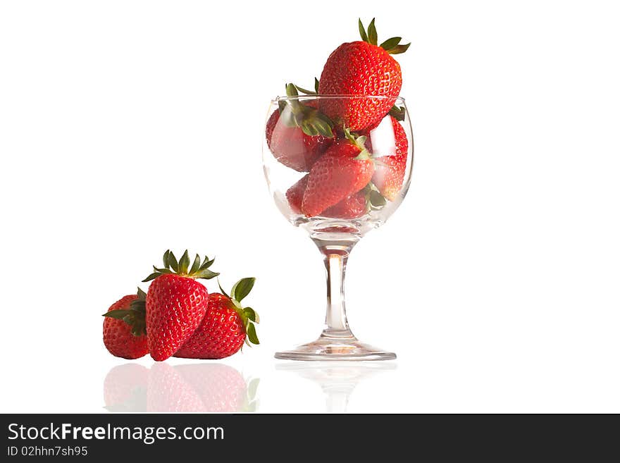 Fresh strawberries in a glass on white background