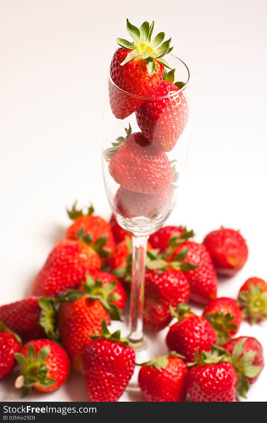 Strawberries in a glass on white background