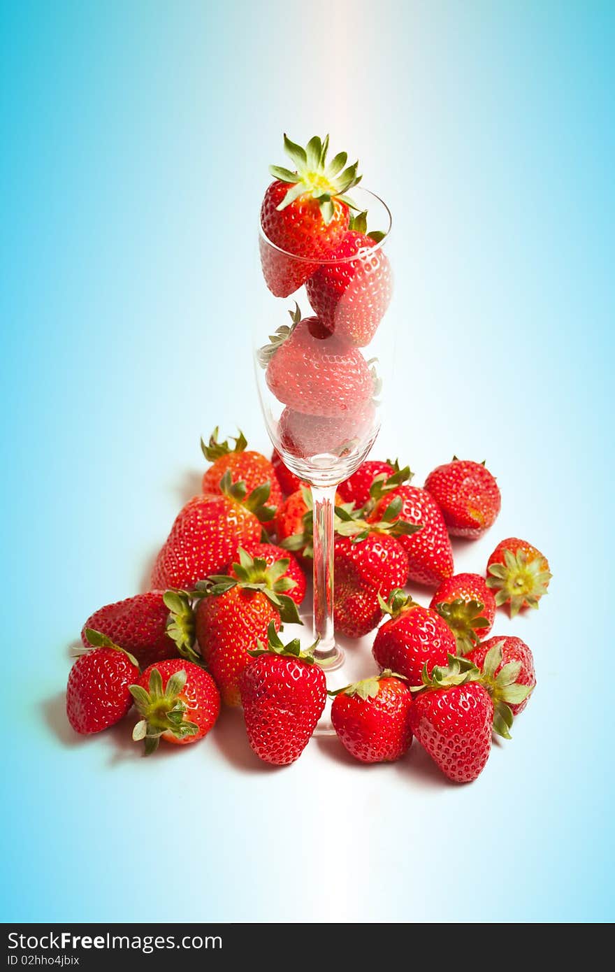 Fresh strawberries in glass on blue background. Fresh strawberries in glass on blue background