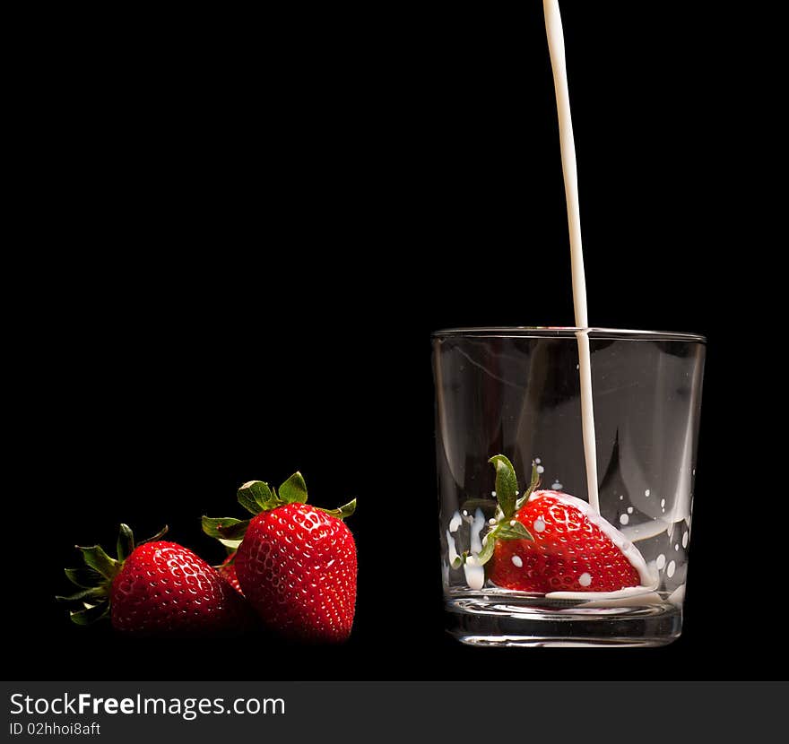 Strawberries in a glass on black background