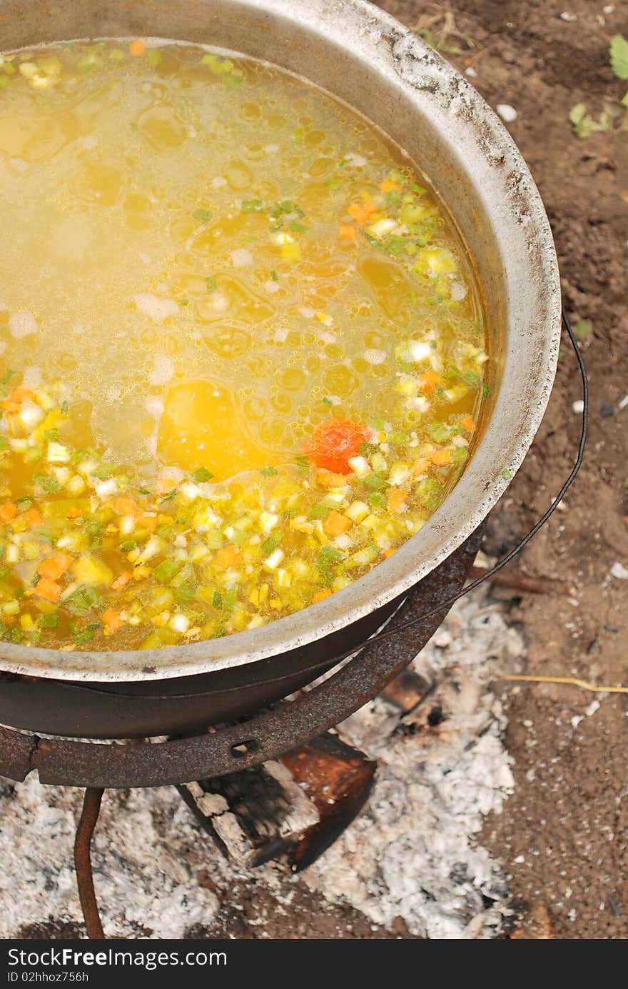 Fish soup in large kettle on fire outside. Fish soup in large kettle on fire outside