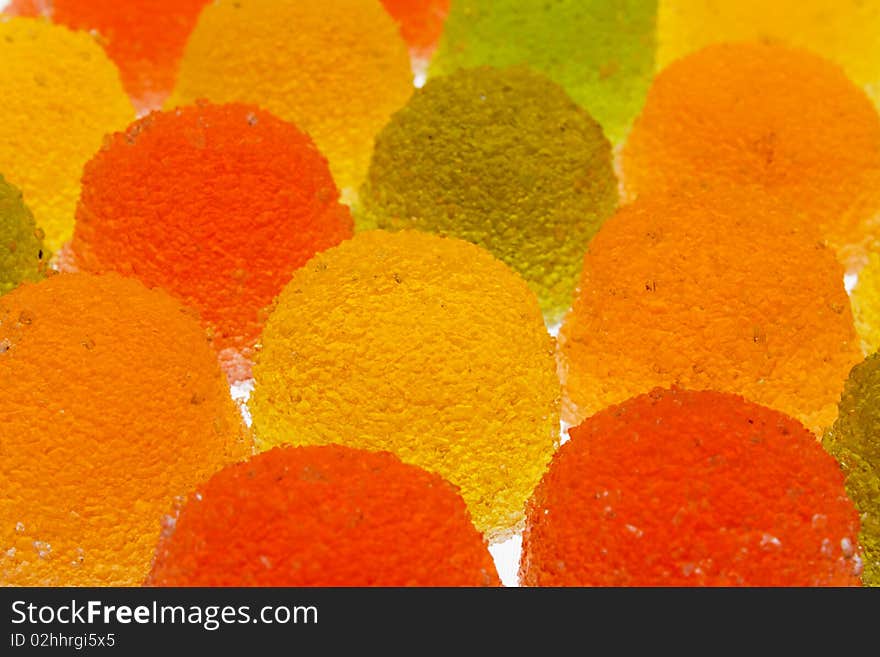 Background of green, yellow, orange and red fruit candyes. Background of green, yellow, orange and red fruit candyes