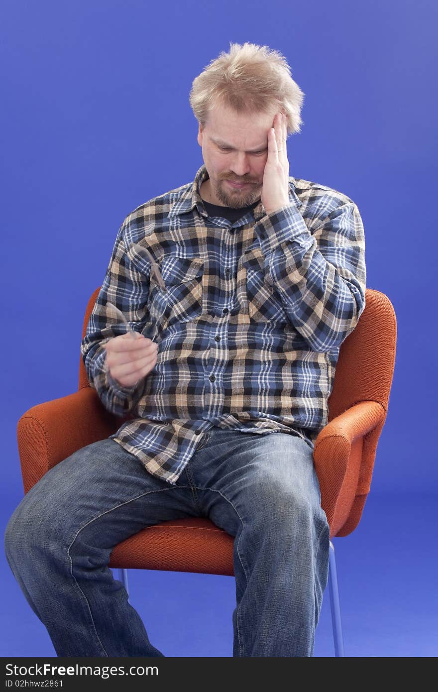 Tired Man Sitting On A Chair