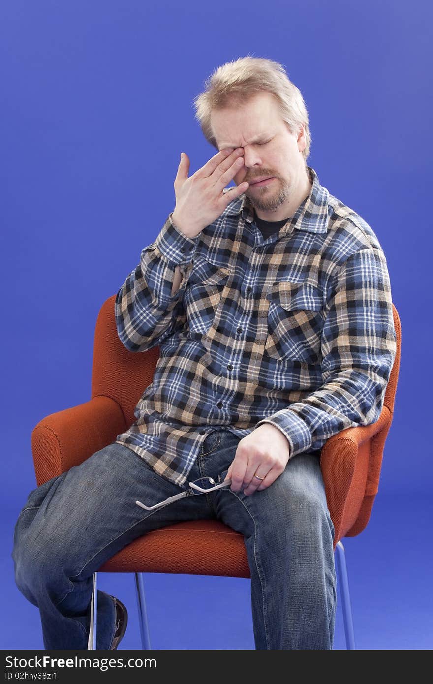 Tired Man Sitting On A Chair