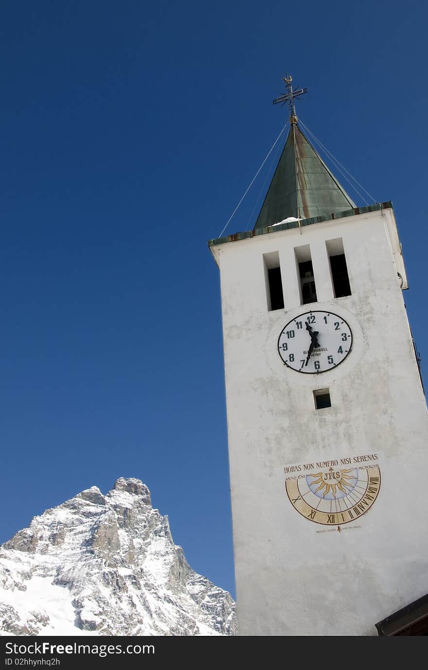 Picture of a bell tower and mount Cervino in background