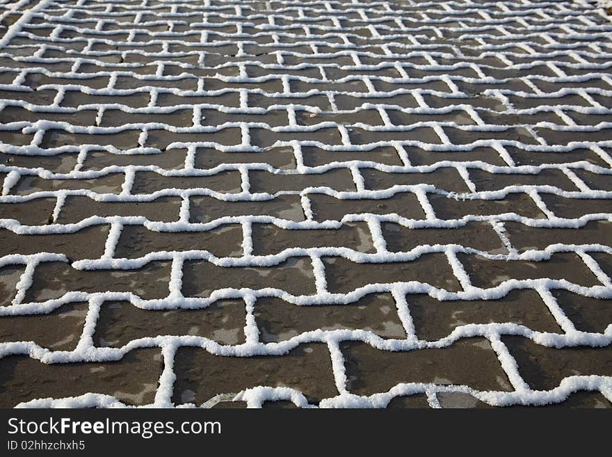 Snow texture on paving slab in winter