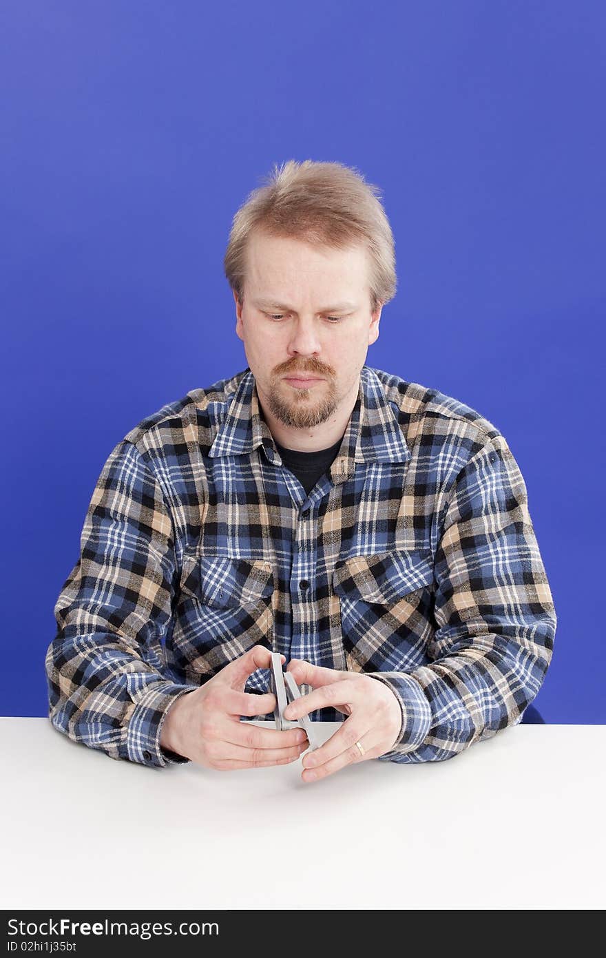 Man mixes cards when playing solitaire/patience.