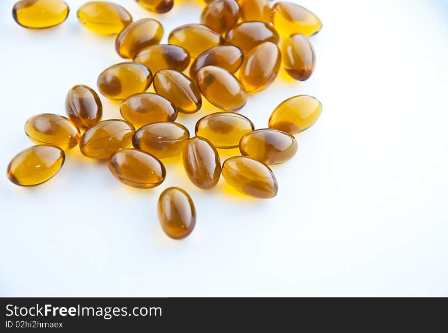 A cluster of rice oil capsules isolated against a white background. A cluster of rice oil capsules isolated against a white background