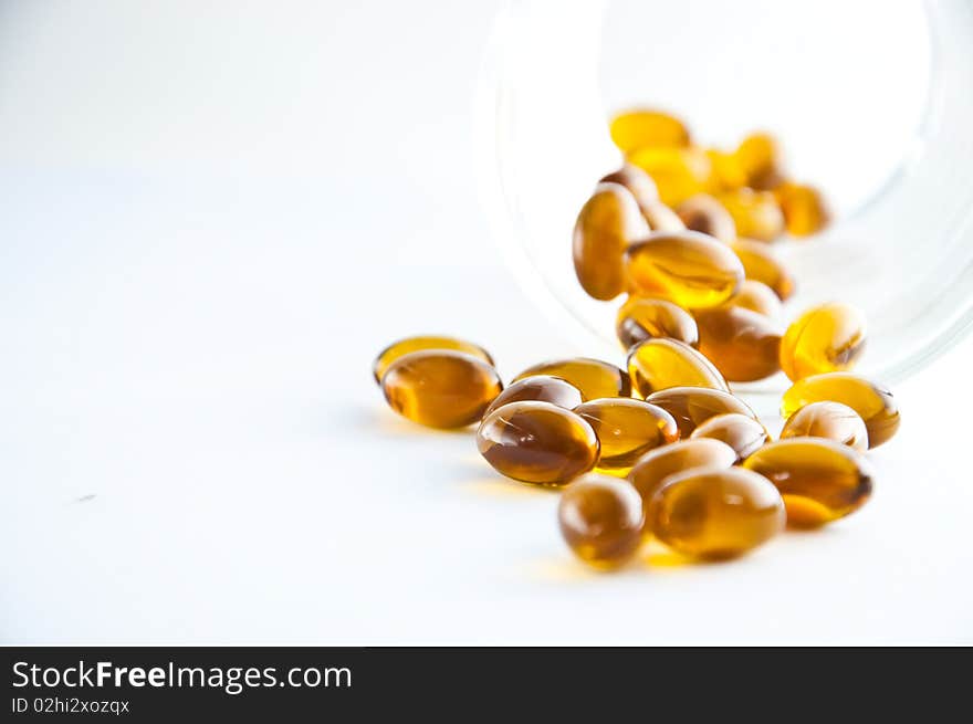 A cluster of rice oil capsules isolated against a white background. A cluster of rice oil capsules isolated against a white background