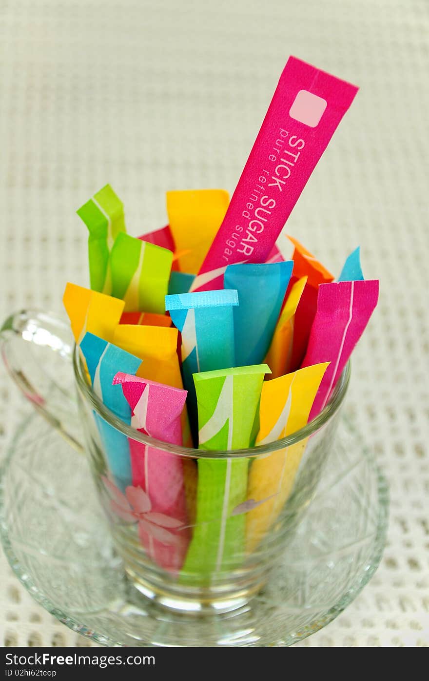 Colourful sugar stick in transparent cup. Colourful sugar stick in transparent cup.