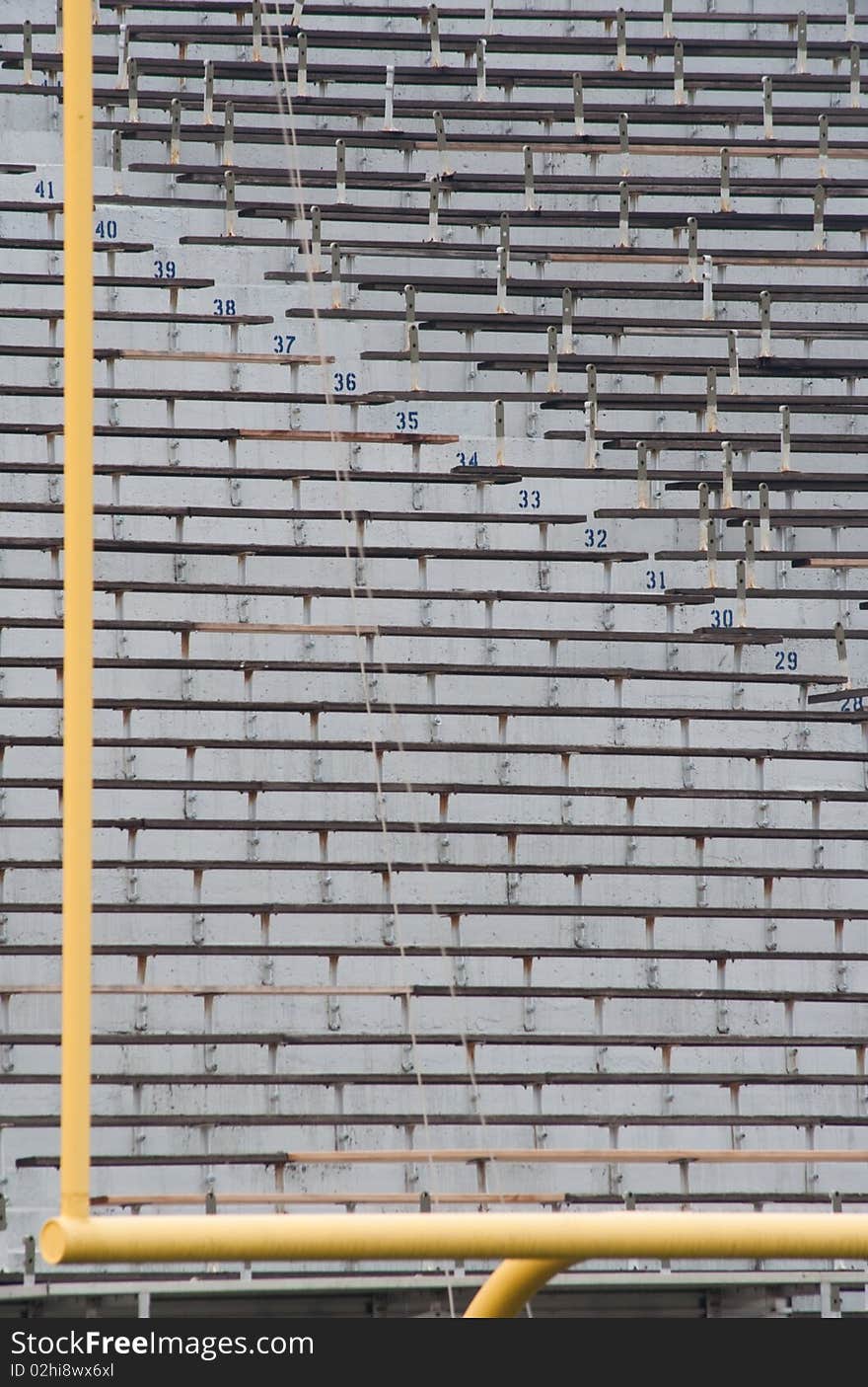 Football goal post with empty stadium seating in background. Football goal post with empty stadium seating in background