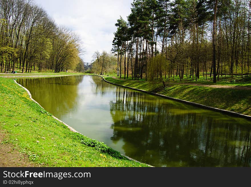 Landscape in the park in early spring, trees and grass