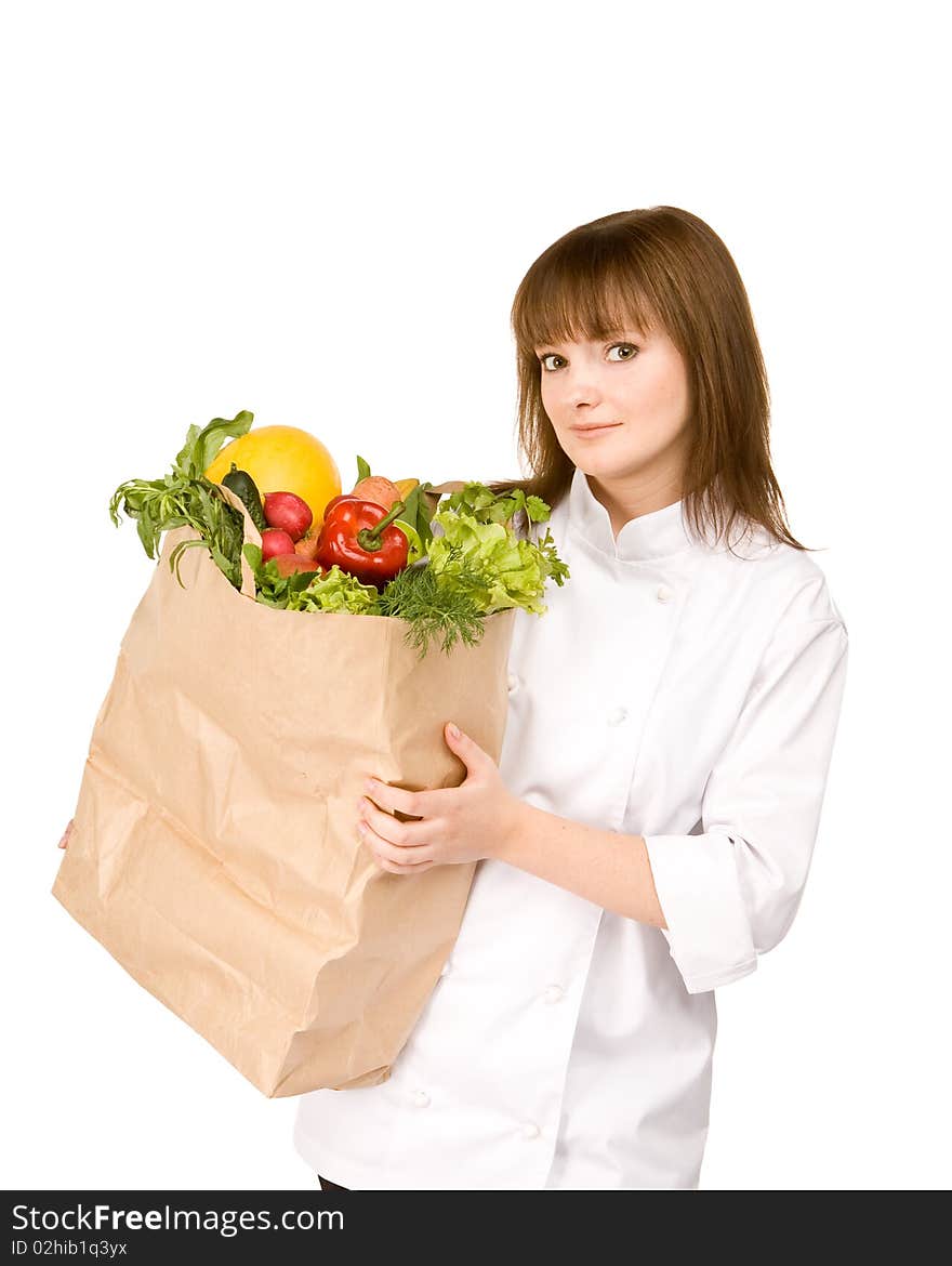 Cook girl holding a paper bag with vegetables