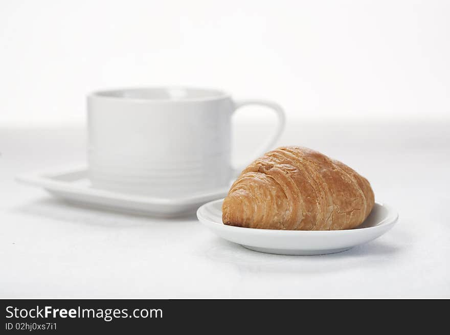 Croissant and cup of coffee/tea