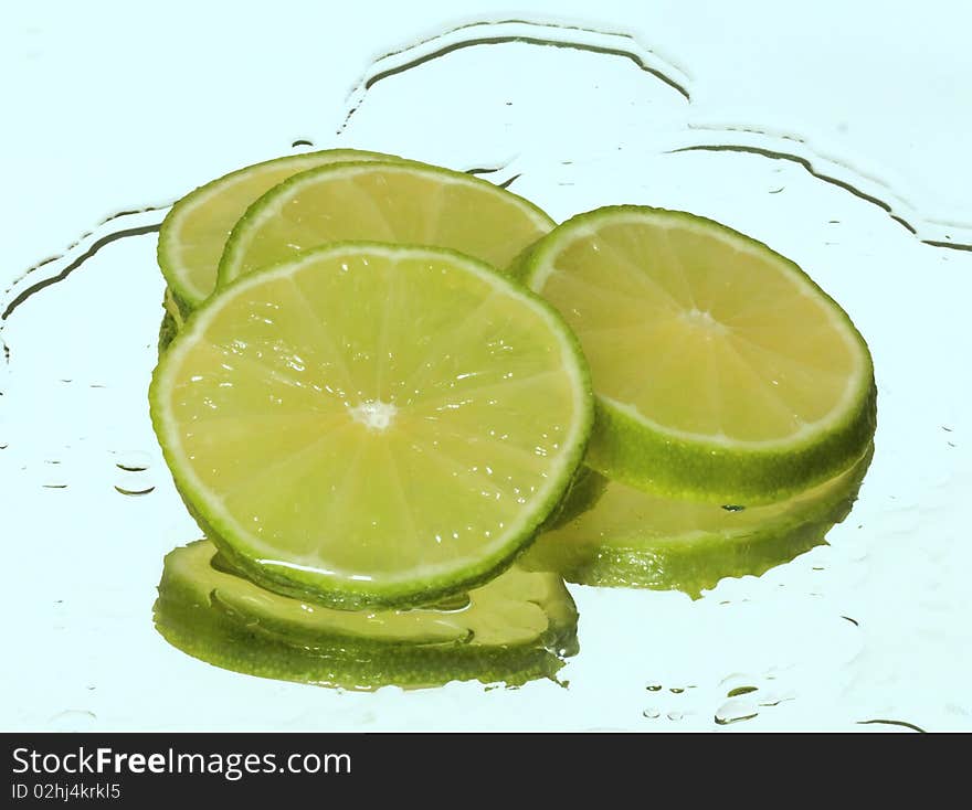 Lime in water on a blue background