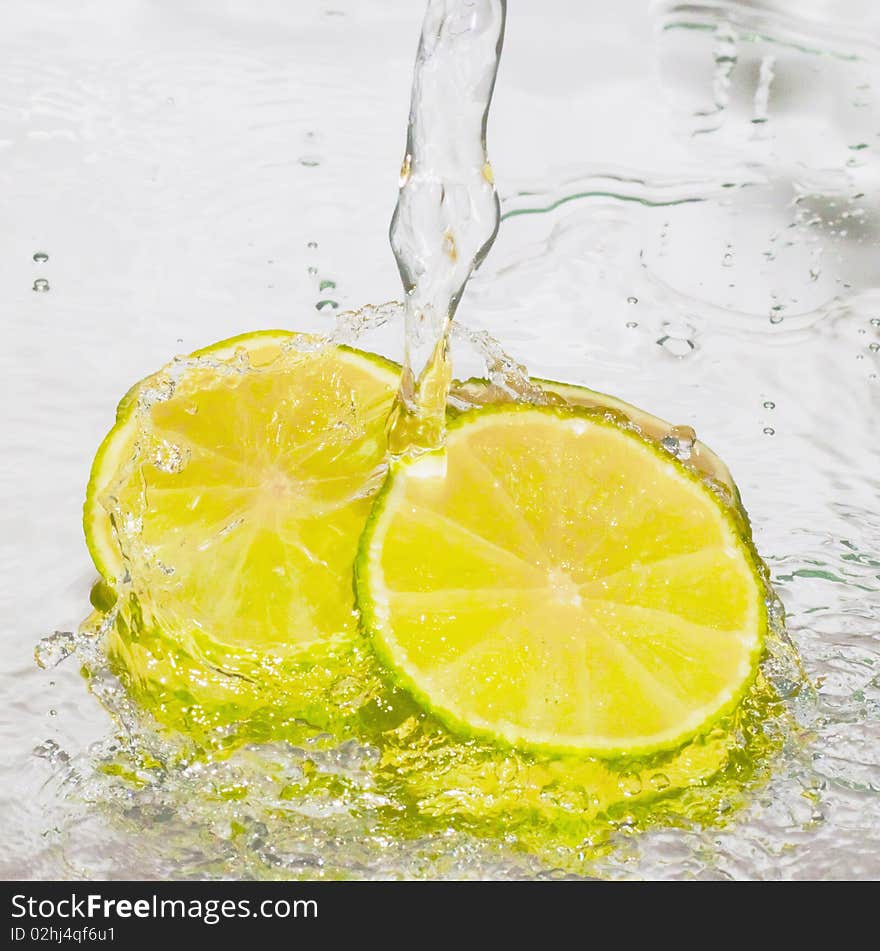 Lime in water on a blue background