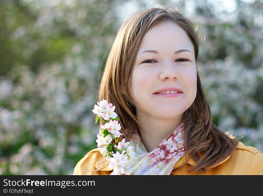 Young woman in blooming park