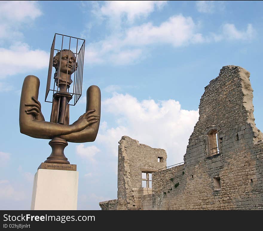 Castle ruins of Marquis de Sade and bronze of the Marquis in Lacoste, France. Castle ruins of Marquis de Sade and bronze of the Marquis in Lacoste, France